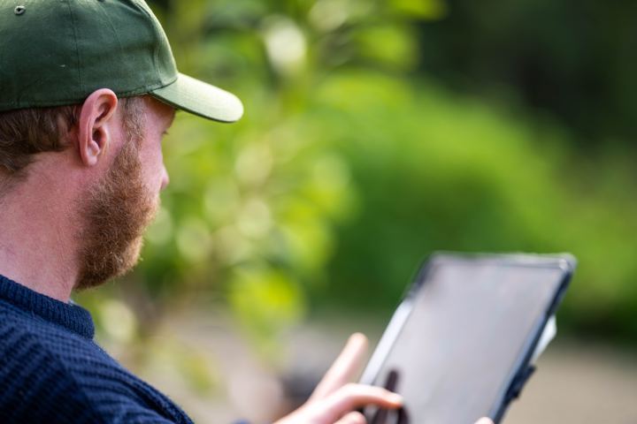 Reviewing a report on a tablet outdoors